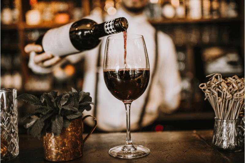 Bartender pouring wine.